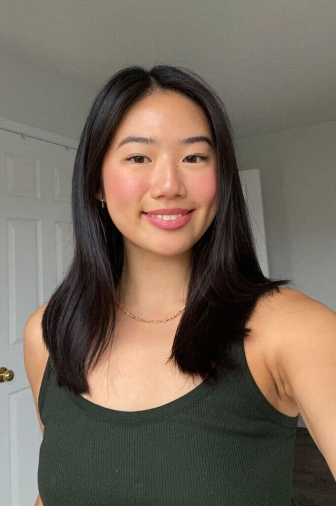 Picture of Jodie Zhu looking at the camera and smiling.